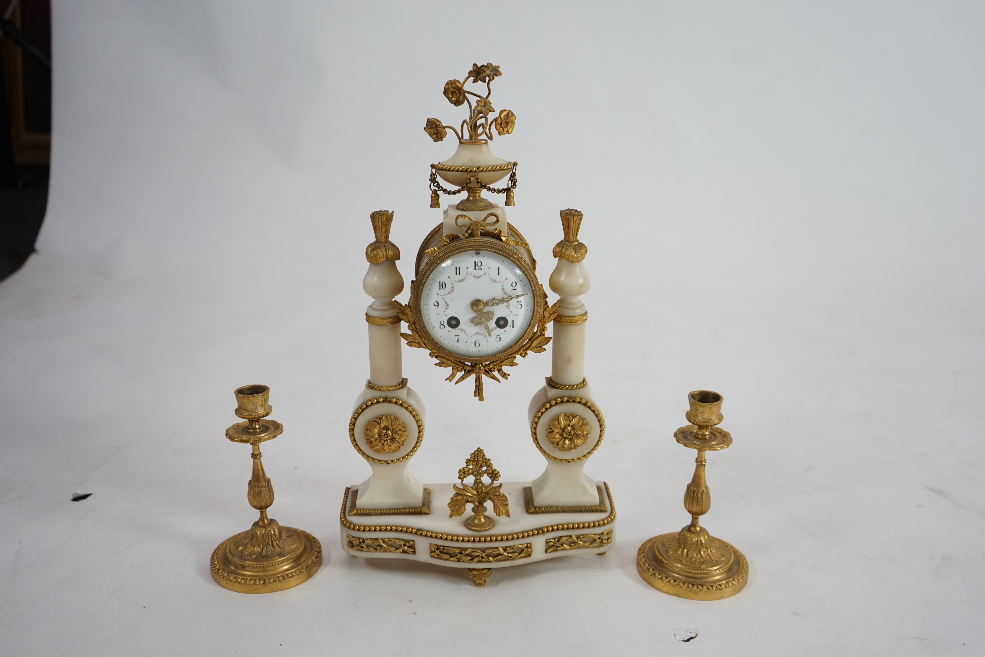 An early 20th century French ormolu mounted white mounted portico clock